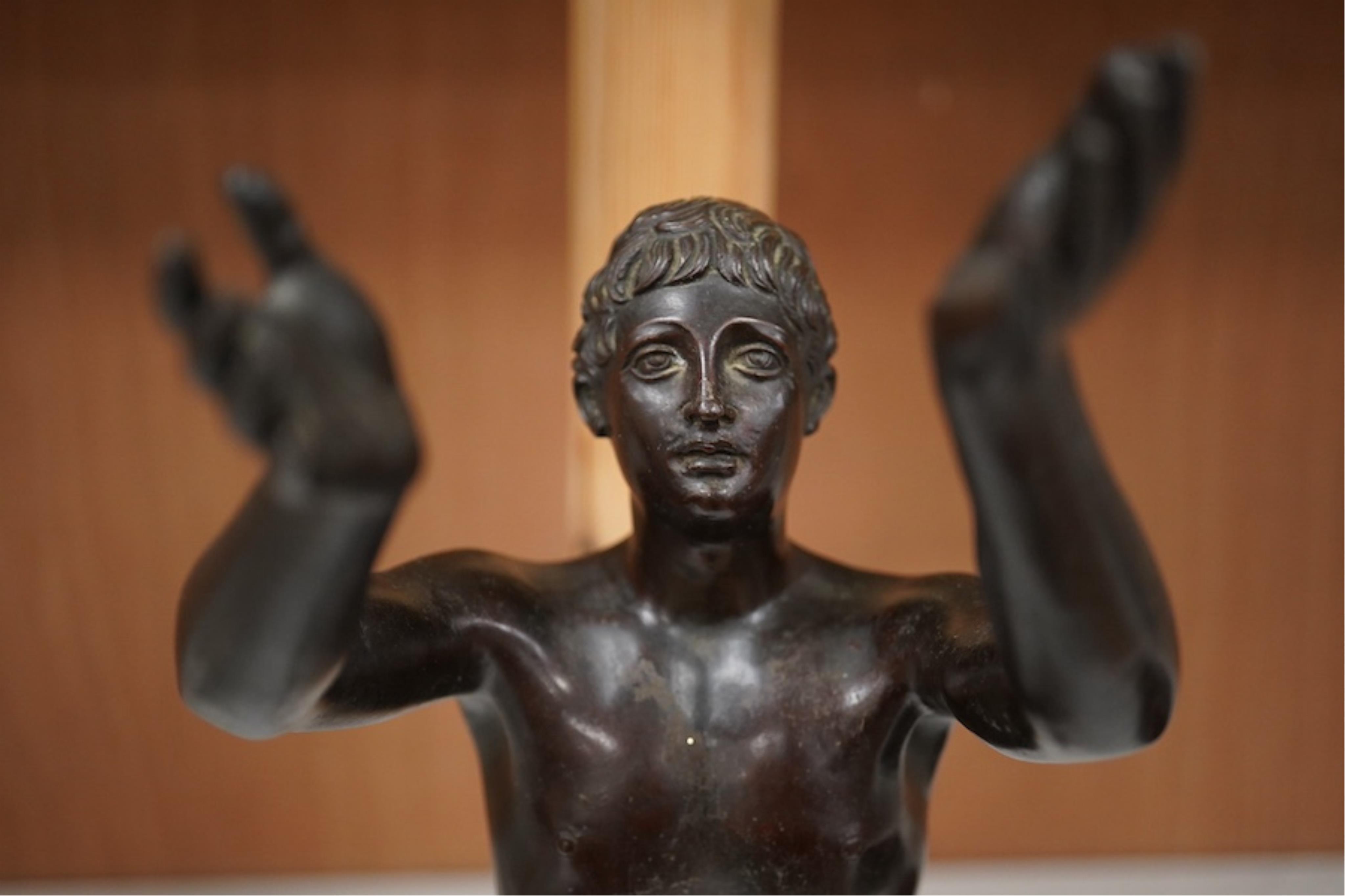 A patinated bronze figure, after the antique ‘The Praying Boy’. 42cm high. Condition - good